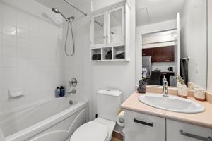 a bathroom with a sink and a toilet and a tub at High Floor 1 Bedroom Condo City View Downtown Toronto in Toronto +12 photos