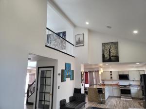 a kitchen and a living room with a staircase and a living room at Denver Layover B&B in DEN