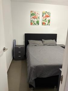 a bedroom with a bed and two pictures on the wall at MIRAMAR V in Torrevieja