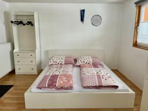 a bedroom with a bed with two pillows on it at Ferienwohnung Fink in Langenegg