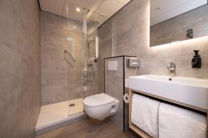 a bathroom with a toilet and a shower and a sink at Fletcher Boutique Hotel De Kromme Dissel in Heelsum +12 photos