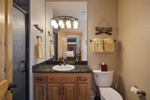 a bathroom with a sink and a toilet and a mirror at 5 Vine Maple in Sunriver +53 photos