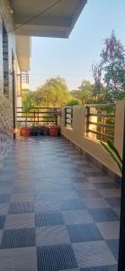 a balcony of a house with a tile floor at Puneetha home stay hampi in Hampi