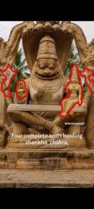 a statue of a woman sitting on a ledge at Puneetha home stay hampi in Hampi +1 photo