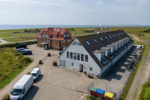 an aerial view of a large building with a van parked in front at Hafenloft App 3 in Norderney