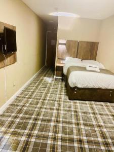 コベントリーにあるハイランズ ホテルのベッドとテレビがあるホテルの部屋