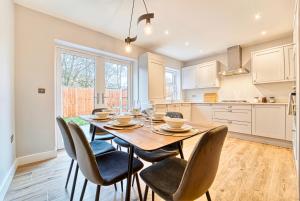 a dining room with a table and chairs at Central and Stylish, Garden and Parking in Coventry