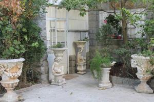 a group of vases sitting in a garden at Cascais Jasmim Doce in Cascais