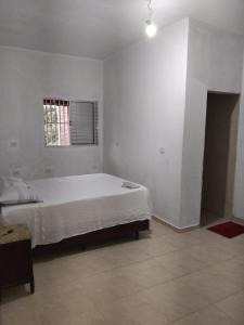 Ένα ή περισσότερα κρεβάτια σε δωμάτιο στο Chácara Amorim +29 φωτογραφίες