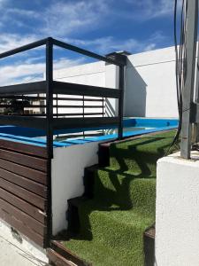 a balcony with a fence and a swimming pool at depto a 1 cuadra de peatonal, luminoso con pile y cochera in Villa Carlos Paz