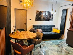 a living room with a table and a couch at GZP Residence Lugoj 4 in Lugoj