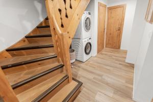 a staircase leading to a laundry room with a washing machine at Chalet 8p Villars-sur-Ollon, Parking et Jardin in Ollon