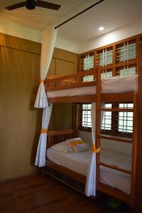 a bedroom with bunk beds in a house at Mother's Inn Homestay in Cochin