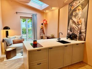 a kitchen with a dog painting on the wall at Villa Wickenburg in Salzburg +92 photos