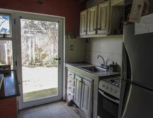 a kitchen with a sink and a door to a yard at La Maruja de Acantilados in Mar del Plata +42 photos