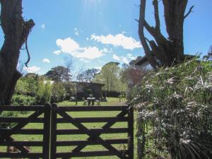 a wooden fence in front of a field with trees at La Maruja de Acantilados in Mar del Plata