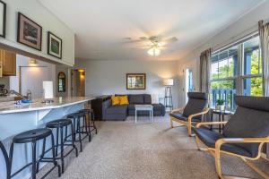 a kitchen and living room with a bar and a couch at 28 Lodge in Hood River