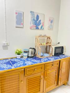 una cocina con encimera y microondas en Baan Amila, en Phra Ae beach