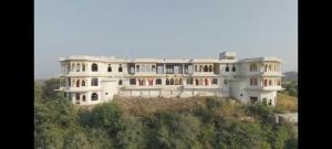 a large white house on top of a hill at Govind Garh Nathdwara in Namano +24 photos