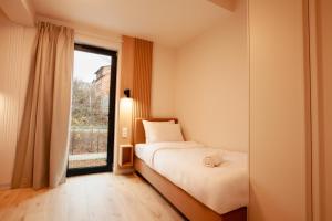 Ένα ή περισσότερα κρεβάτια σε δωμάτιο στο Lake View Żywiec Resort & SPA +41 φωτογραφίες
