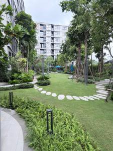 a park with a large building in the background at DCondo Kathu ใกล้หาดป่าตอง in Kathu +27 photos