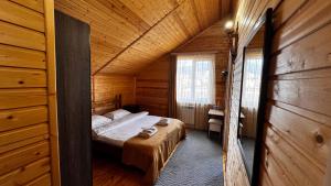 a bedroom with a bed in a wooden cabin at COTTAGE CHALET and TOURS in Dilijan
