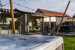 a hot tub in the backyard of a house at De Hoeveschuur in Riemst