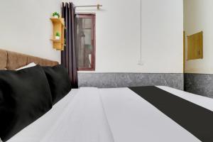a bedroom with a bed and a window at Hotel O Second Home Residency in Dehradun