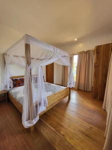 a bedroom with a bed with a canopy at Hondo Hondo mountain view in Lushoto