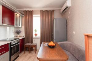a kitchen with a table with a bowl of fruit on it at Standard 1-bd Apartment LAVINA in Sumy