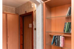 a room with wooden shelves with books and a door at Standard 1-bd Apartment LAVINA in Sumy