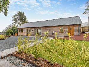 a wooden house with a garden in front of it at 1 Bed in Leominster 95609 in Pencombe