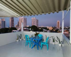 a table and chairs on a balcony with a view of the city at Hospedaje Torices Cartagena in Cartagena de Indias