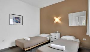 a room with two beds and a mirror at Apartamentos LIVVO Mar Azul - Adults Only in Corralejo +31 photos