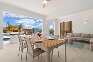 a dining room with a table and a couch at Kasa Blou in Kralendijk