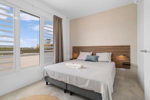 a bedroom with a bed and a large window at Kasa Blou in Kralendijk +45 photos