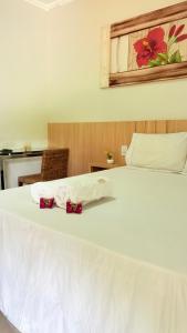 Ένα ή περισσότερα κρεβάτια σε δωμάτιο στο Chalés Ipê do Lago +38 φωτογραφίες