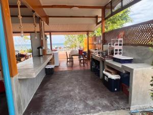 an outdoor kitchen with a view of the ocean at Ban slow life Koh Libong in Ko Kwang