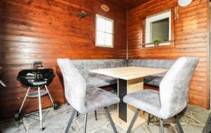 a table and chairs in a room with wooden walls at Apartment in Inzing in Inzing