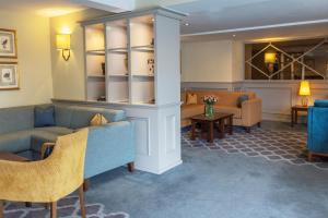 a waiting room with couches and chairs and a table at Kings Court Hotel Alcester, BW Signature Collection in Stratford-upon-Avon