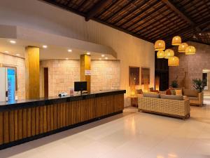 a hotel lobby with a bar and a couch at Girassol Praia Hotel in Porto Seguro +30 photos