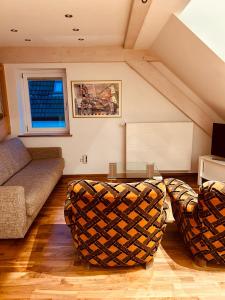 a living room with a couch and a table at Pension Mimosa in Rust