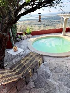 a swimming pool with a bench and a table at Casa La Vista in San Miguel de Allende
