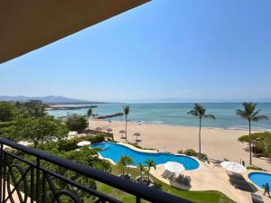 a view of the beach from the balcony of a resort at Luxury Oceanfront Penthouse Concierge Cook in Punta Mita