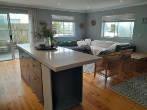 a kitchen and living room with a large island at Sunbird 2 in Cape St Francis