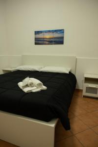 Postel nebo postele na pokoji v ubytování Trifamiliare Garden - Mare