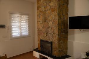 TV a/nebo společenská místnost v ubytování Trifamiliare Garden - Mare