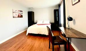 a bedroom with a bed and a desk and a table at Cozy Queen room with Shared Bath near Seneca Finch 404 in Toronto