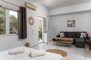 a living room with a bed and a couch at Mirtos4seasons Harmony in Myrtos