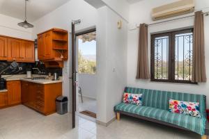 a kitchen with a green couch and a window at Mirtos4seasons Harmony in Myrtos